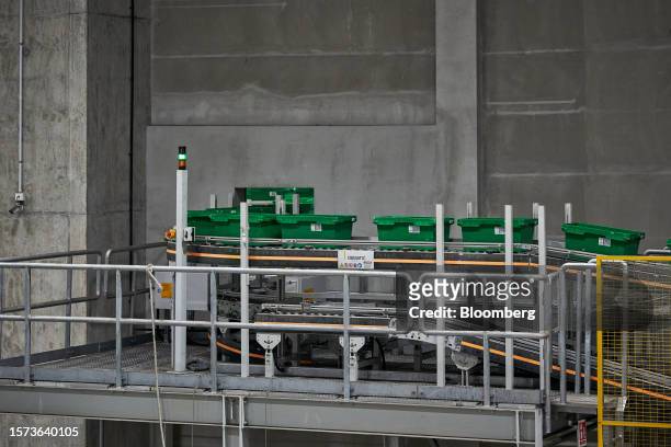 Crates travel on a conveyor at RedMart Ltd.'s West Fulfillment Center in Singapore, on Friday, Oct. 22, 2021. Lazada Group SA, the Southeast Asian...