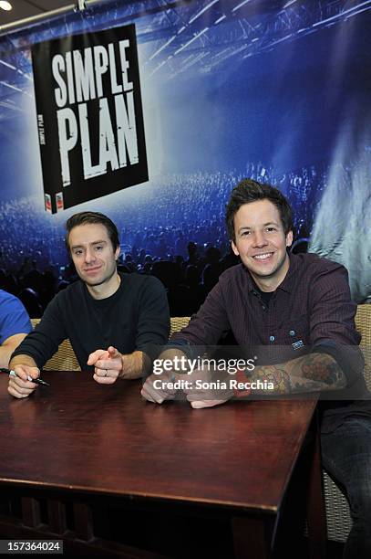 Musicians Sebastien Lefebvre and Pierre Bouvier attend "Simple Plan: The Official Story" book signing at Chapters Indigo on November 29, 2012 in...