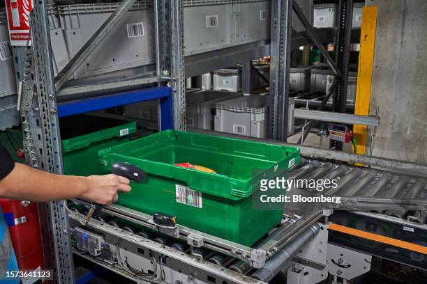 An employee scans a bar code on a crate at RedMart Ltd.'s West Fulfillment Center in Singapore, on Friday, Oct. 22, 2021. Lazada Group SA, the...