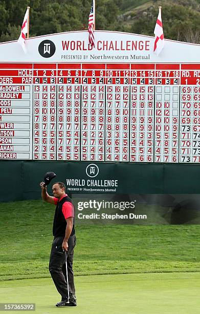 Tips his cap after putting out on the 18th green during the final round of the Tiger Woods World Challenge Presented by Northwestern Mutual at...