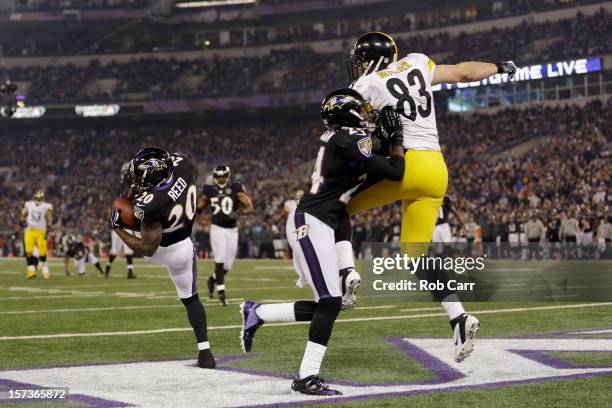 Free safety Ed Reed of the Baltimore Ravens intercepts a pass intended for tight end Heath Miller of the Pittsburgh Steelers as Corey Graham blocks...