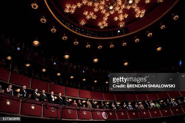 First Lady Michelle Obama and US President Barack Obama and others listen to the US national anthem during the 2012 Kennedy Center Honors at the...