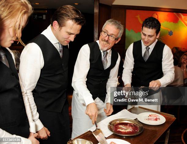 Actors Freddie Fox, working as barman, Stefan Booth and Griff Rhys Jones, working as waiters, attend One Night Only at The Ivy, featuring 30 stage...