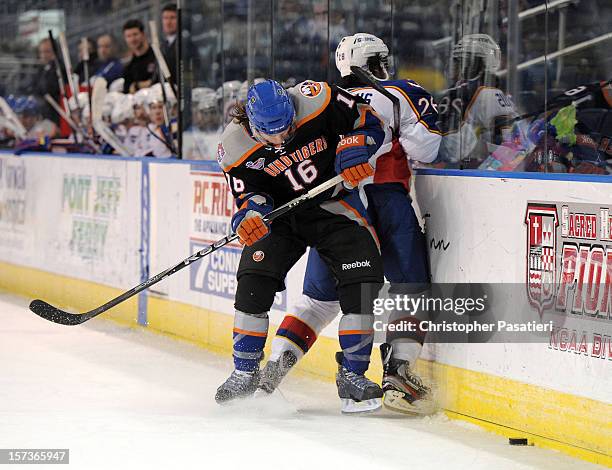 Sean Backman of the Bridgeport Sound Tigers checks Nick Schaus of the Norfolk Admirals during an American Hockey League game on December 2, 2012 at...