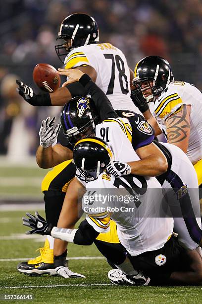 Quarterback Charlie Batch of the Pittsburgh Steelers is hit by nose tackle Ma'ake Kemoeatu of the Baltimore Ravens while throwing a third quarter...
