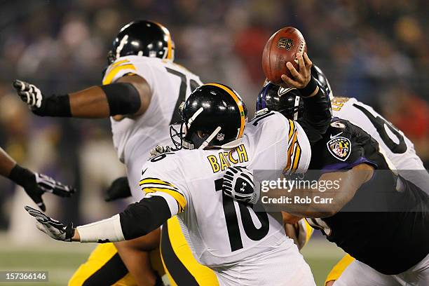 Quarterback Charlie Batch of the Pittsburgh Steelers is hit by nose tackle Ma'ake Kemoeatu of the Baltimore Ravens while throwing a third quarter...