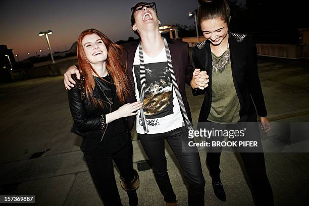 young adults laughing together - evening walk stock pictures, royalty-free photos & images