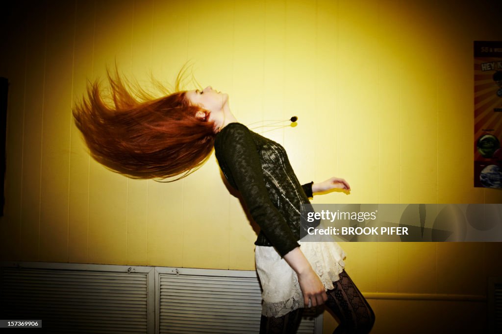 Young woman flipping hair