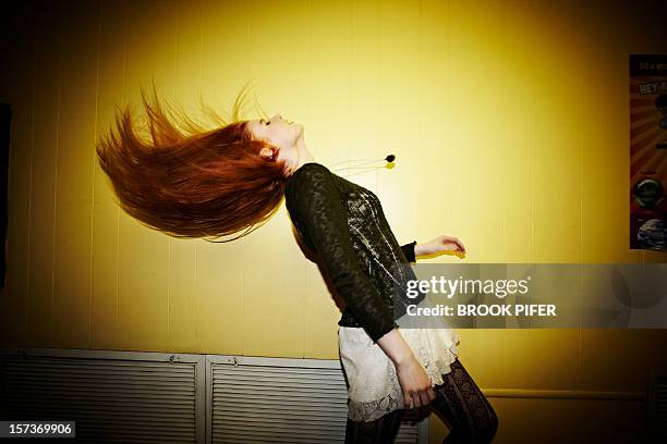 young woman flipping hair - hair toss stock pictures, royalty-free photos & images