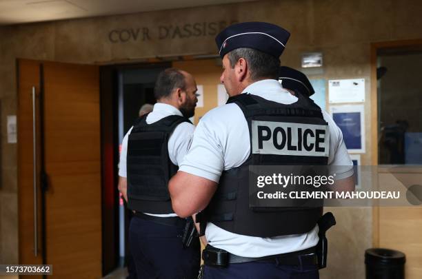 French police officers stand at the entrance of the Courtroom in Aix-en-Provence on August 3 as the Court of Appeal is examining the appeal on the...