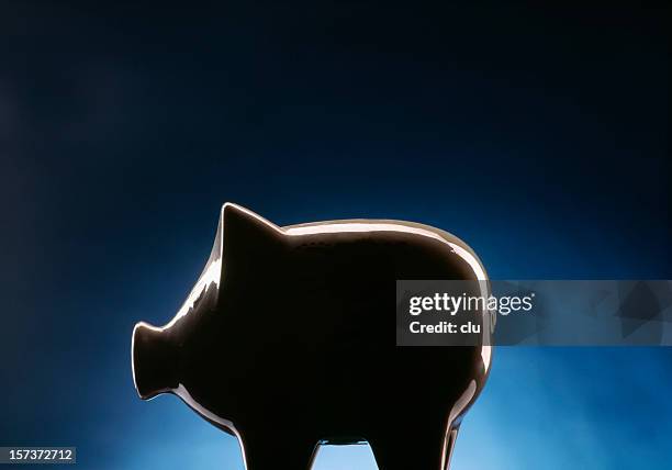 piggy bank on dark blue black background - dark humor stock pictures, royalty-free photos & images