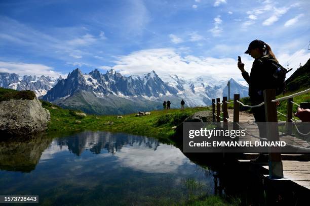 Visitors hike on a newly-built structure to preserve nature on a trail leading to the Lac Blanc and the Lacs des Cheserys area in the Aiguilles...