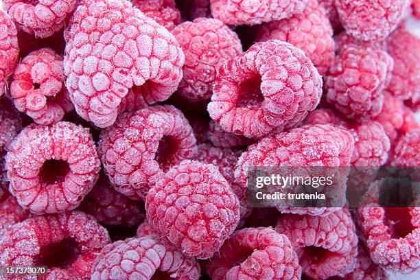 frozen raspberries - frozen water stock pictures, royalty-free photos & images