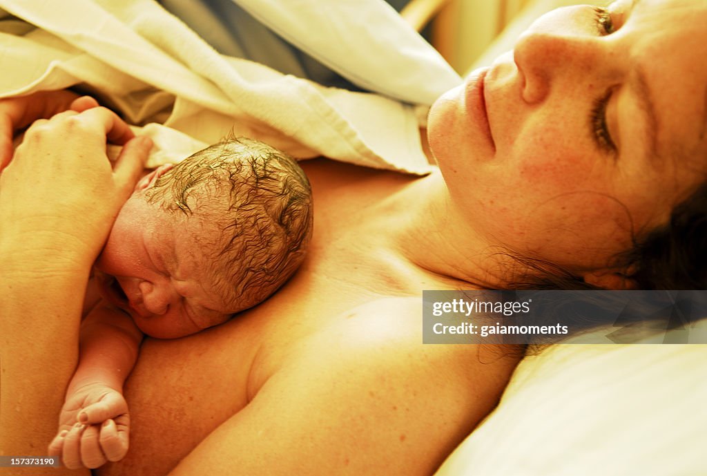 Newborn Baby Lying on Mother