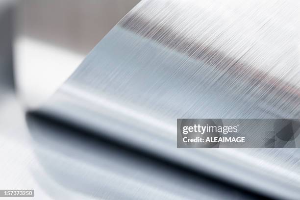 close-up of a metallic sheet that is rolled up - foil stock pictures, royalty-free photos & images