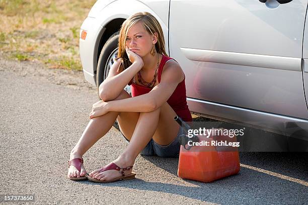 teenage girl by a stalled car - benzinekan stockfoto's en -beelden