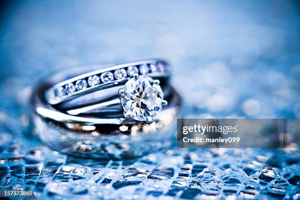 platinum rings on shattered glass (ice blue) - silver ring stock pictures, royalty-free photos & images