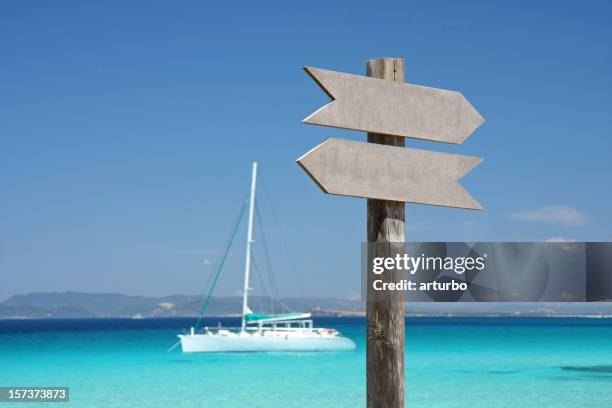 turquoise mediterranean sea with sign and yacht - wooden sign post stock pictures, royalty-free photos & images