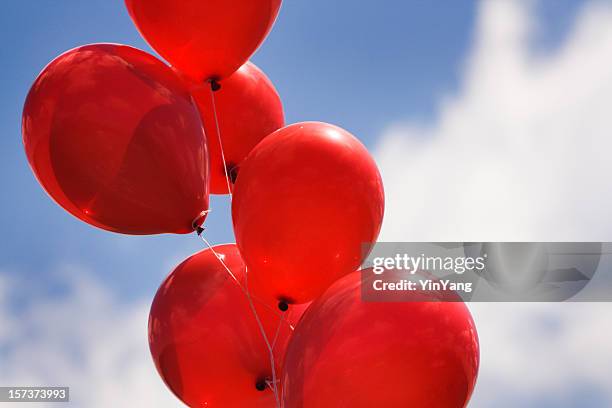 helium party balloons against sky for celebration events - red event in bildbanksfoton och bilder