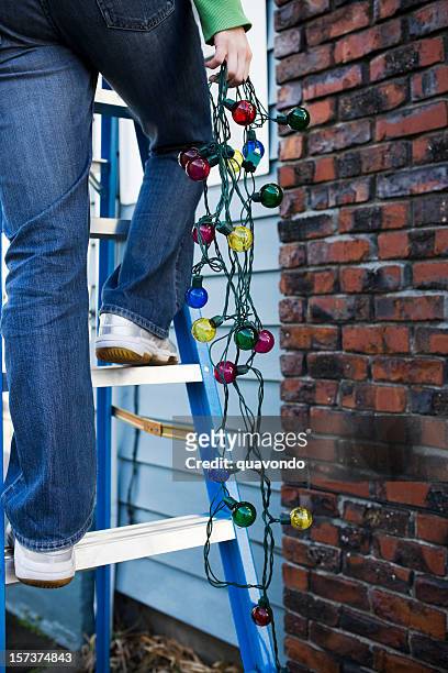 christmas lights hanging from ladder outside chimney, copy space - hanging christmas lights stock pictures, royalty-free photos & images