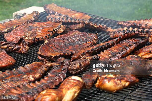 ribs and chicken over the barbecue pit - smoked bbq ribs stock pictures, royalty-free photos & images