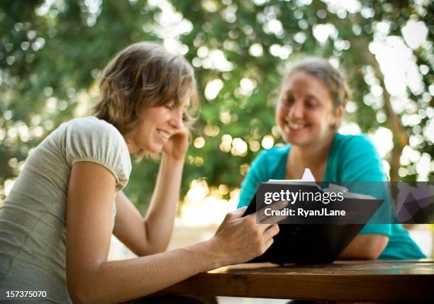 student friends reading the bible - teaching generosity stock pictures, royalty-free photos & images