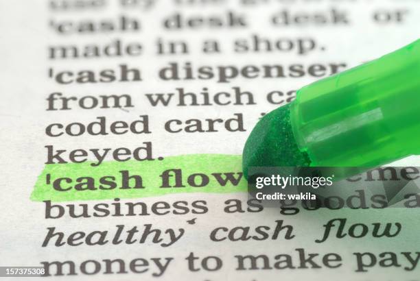 cash flow definition highlighted in dictionary - cashflow stock pictures, royalty-free photos & images