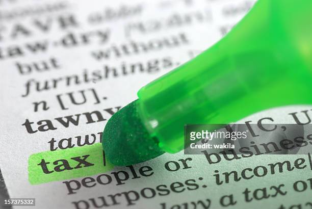 tax defintion highlighted in dictionary - tax law stock pictures, royalty-free photos & images