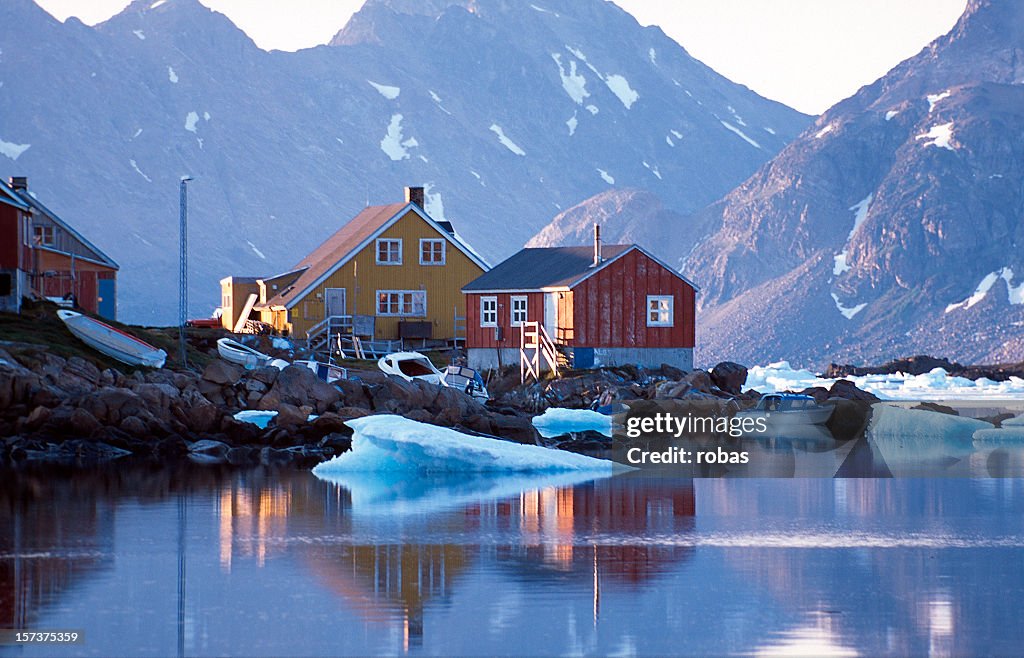 Waterfront homes in Greenland with mountains in background