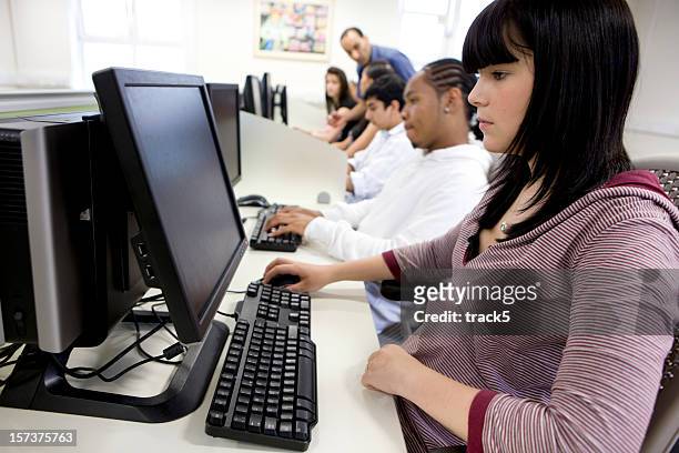 further education: concentration on the faces of learners using computers - man and machine stock pictures, royalty-free photos & images