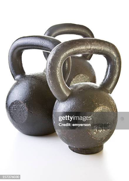 three kettle bell weights on a white background - kettle isolated stock pictures, royalty-free photos & images