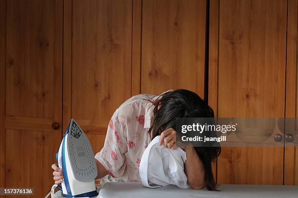 depressed woman, with iron and man's shirt - housewife stock pictures, royalty-free photos & images