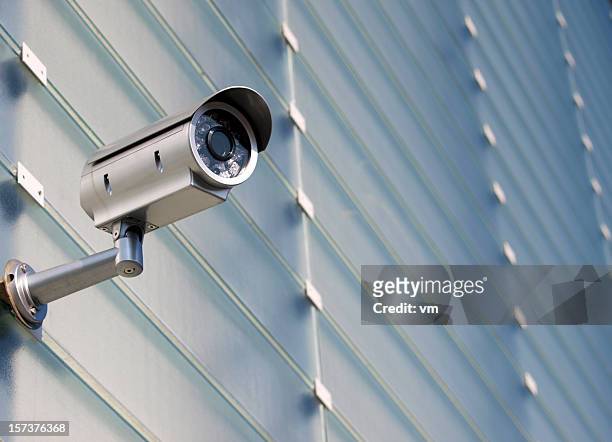 surveillance camera on glass facade - security camera stock pictures, royalty-free photos & images