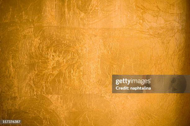 a shiny gold textured background - foil stock pictures, royalty-free photos & images