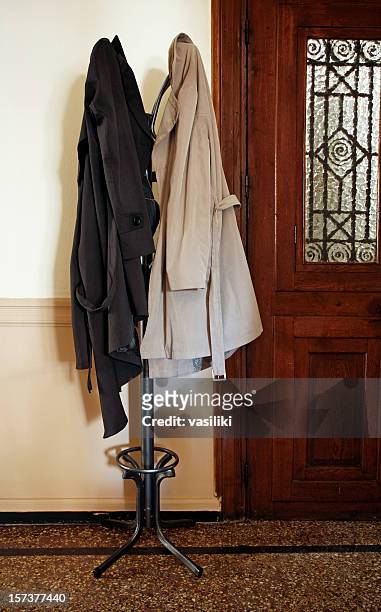 coat rack with overcoats - overcoat stock pictures, royalty-free photos & images