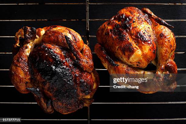 two roasted chickens still on the grill - roast chicken stock pictures, royalty-free photos & images