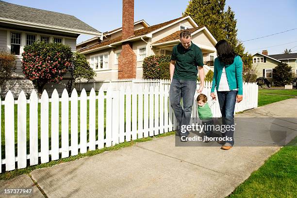 young family taking a stroll - small town community stock pictures, royalty-free photos & images
