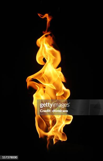 fire flame against black background. - fakkel stockfoto's en -beelden