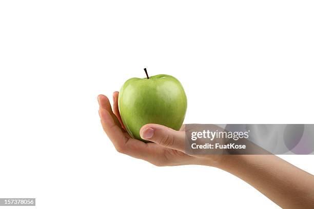 green apple - hand holding an apple stock pictures, royalty-free photos & images