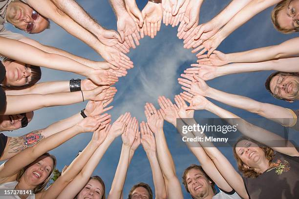 group of people with hands in a circle - sea of hands stock pictures, royalty-free photos & images