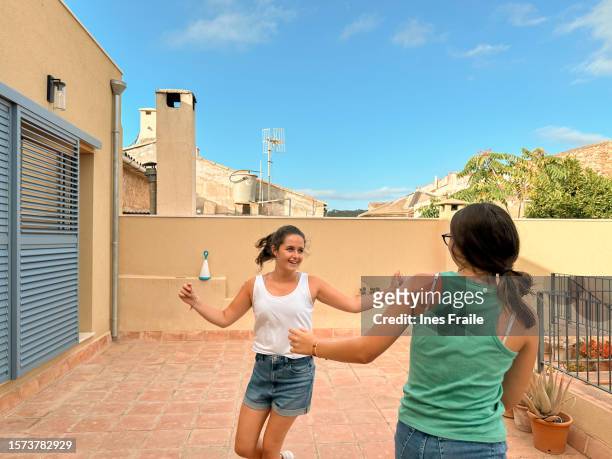 two young girls dancing traditional dances in the backyard - fashion suit stock pictures, royalty-free photos & images