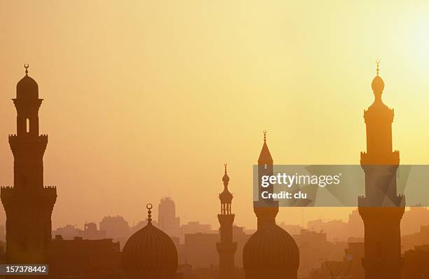 cairo sunset with towers - minaret stockfoto's en -beelden
