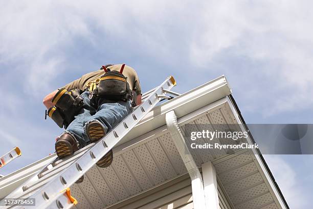 home repairs handyman up a ladder outdoors - roof repair stock pictures, royalty-free photos & images