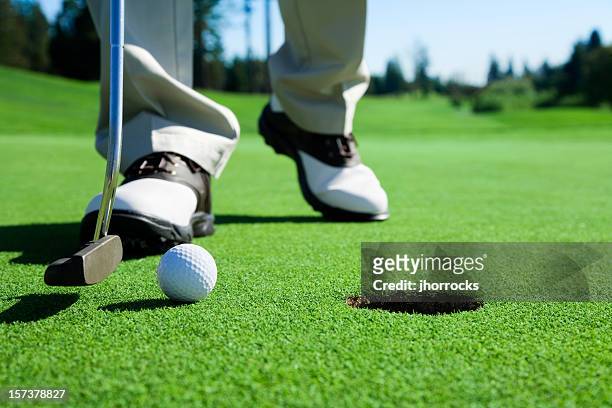 golfer tapping in - golf accessories stock pictures, royalty-free photos & images