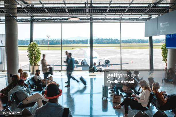 diverse people casually waiting at departures terminal - indian family vacation stock pictures, royalty-free photos & images