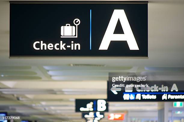 airport check-in area - airport signage stock pictures, royalty-free photos & images