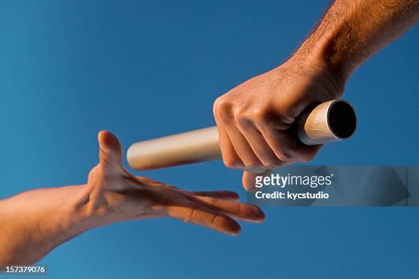two hands passing relay baton race - relay 個照片及圖片檔