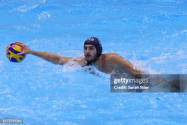 Dorde Vucinic of Team Serbia controls the ball in the Men's Water Polo Semifinal match between Greece and Serbia on day 12 of the Fukuoka 2023 World...