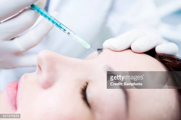 cosmetic botox treatment - botox injection stock pictures, royalty-free photos & images