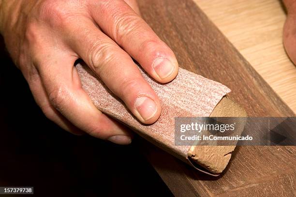 close-up of a man sanding by hand in the workshop - mahogny bildbanksfoton och bilder